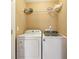 Practical laundry room with washer, dryer, and a shelf for storage at 220 Turnstone Rd, Stockbridge, GA 30281