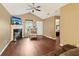 Living room featuring hardwood floors, a fireplace, and open doorway leading to a bedroom at 220 Turnstone Rd, Stockbridge, GA 30281