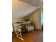 A cluttered attic space with hardwood floors, chair, and storage at 2689 Knox Ne St, Atlanta, GA 30317