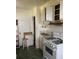 A kitchen with white cabinets, a vintage stove, and green tile flooring at 2689 Knox Ne St, Atlanta, GA 30317
