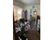 Cluttered living room with hardwood floors, a window with blinds, and open access to the kitchen at 2689 Knox Ne St, Atlanta, GA 30317