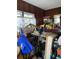 A cluttered room with wood-paneled walls and a window with sheer curtains at 2689 Knox Ne St, Atlanta, GA 30317