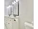 Bright bathroom featuring double sinks, granite countertops, and black fixtures, offering a modern and functional space at 2944 Berry Rd, Loganville, GA 30052