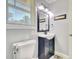 Cozy bathroom with pedestal sink, decorative mirror, and natural light from the window at 2944 Berry Rd, Loganville, GA 30052