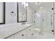 Modern bathroom with white marble tile, gray granite counters, custom cabinets, and glass-enclosed shower at 2944 Berry Rd, Loganville, GA 30052