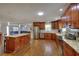Open kitchen featuring wood cabinets, stainless steel appliances, and a large island with granite countertops at 2944 Berry Rd, Loganville, GA 30052