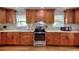 Updated kitchen with wood cabinets, granite countertops, stainless steel appliances, and white marble backsplash at 2944 Berry Rd, Loganville, GA 30052