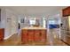 Spacious kitchen featuring wood floors, a large island with granite countertops, and open flow to other living areas at 2944 Berry Rd, Loganville, GA 30052