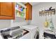 Efficient laundry area featuring a modern washer and dryer, accompanied by convenient storage cabinets and shelving at 2944 Berry Rd, Loganville, GA 30052