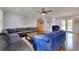 Spacious living room featuring a large sectional couch, wood floors, and a wall decal with inspirational quotes at 2944 Berry Rd, Loganville, GA 30052