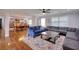 Inviting living room with blue and gray couches, colorful rug, and open flow to dining area and bookshelves at 2944 Berry Rd, Loganville, GA 30052