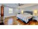 Spacious main bedroom with hardwood floors, complemented by neutral decor and bright natural light at 2944 Berry Rd, Loganville, GA 30052