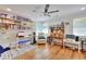 Inviting home office featuring hardwood floors, abundant shelving, a ceiling fan, and natural light at 2944 Berry Rd, Loganville, GA 30052