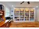 Well-lit office space with custom built-in bookshelves, desk, and hardwood flooring at 2944 Berry Rd, Loganville, GA 30052