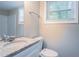 Bathroom featuring a granite vanity, modern faucet, and tiled walls at 5795 Deerfield Trl, Atlanta, GA 30349