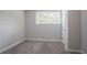 This bedroom is freshly painted and features new carpet, a window, and a closet at 5795 Deerfield Trl, Atlanta, GA 30349