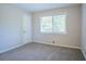 Bedroom with a window view and a neutral carpet and paint is showcased here at 5795 Deerfield Trl, Atlanta, GA 30349
