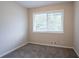 Bedroom with neutral carpet, neutral paint and a window for natural light is captured here at 5795 Deerfield Trl, Atlanta, GA 30349