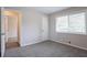 Bedroom featuring neutral carpet and paint with one window bringing in natural light at 5795 Deerfield Trl, Atlanta, GA 30349