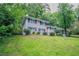 Charming two-story home with a landscaped yard and inviting red front door at 5795 Deerfield Trl, Atlanta, GA 30349