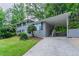 View of gray brick house with carport and well-manicured front lawn at 5795 Deerfield Trl, Atlanta, GA 30349