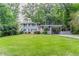 Charming two-story home featuring a well-manicured lawn and a convenient carport at 5795 Deerfield Trl, Atlanta, GA 30349