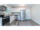 Bright kitchen with white cabinets, stainless steel appliances, and a door to the yard at 5795 Deerfield Trl, Atlanta, GA 30349