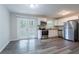 Modern kitchen with stainless steel appliances, white cabinets, and gray backsplash at 5795 Deerfield Trl, Atlanta, GA 30349