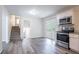 Bright kitchen with white cabinets, stainless steel appliances, and adjacent stairs at 5795 Deerfield Trl, Atlanta, GA 30349