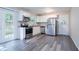 Modern kitchen with stainless steel appliances, white cabinets, and gray backsplash at 5795 Deerfield Trl, Atlanta, GA 30349
