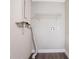 This laundry room has fresh paint, shelving, washer/dryer hookups, and hard surface flooring at 5795 Deerfield Trl, Atlanta, GA 30349