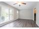 Living room featuring hardwood floors, neutral paint, ceiling fan, and large window at 5795 Deerfield Trl, Atlanta, GA 30349