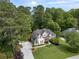 Aerial view of this home and its large yard with manicured landscaping and mature trees at 1605 Little Lisa Ln, Snellville, GA 30078