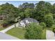 Birds eye view of a two-story home with a long driveway, manicured lawn, and mature trees at 1605 Little Lisa Ln, Snellville, GA 30078