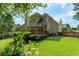 Beautiful backyard with well-maintained lawn, deck, established landscaping, and picturesque home view at 1605 Little Lisa Ln, Snellville, GA 30078