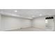 Unfinished basement area with white painted walls and ceiling offers an opportunity for customization at 1605 Little Lisa Ln, Snellville, GA 30078