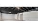 Large unfinished basement space with exposed ceiling and white painted walls with ample potential for customization at 1605 Little Lisa Ln, Snellville, GA 30078