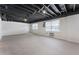 Spacious basement featuring exposed ceiling, natural light, and walk-out doors offers customization possibilities at 1605 Little Lisa Ln, Snellville, GA 30078