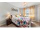 Comfortable bedroom featuring a decorative floral comforter, side tables and natural light at 1605 Little Lisa Ln, Snellville, GA 30078