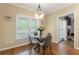 Breakfast nook with a glass table, gray chairs, large windows and wood floors at 1605 Little Lisa Ln, Snellville, GA 30078