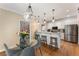 Breakfast nook featuring a glass table, seating for four, hardwood floors, and open access to the kitchen at 1605 Little Lisa Ln, Snellville, GA 30078