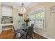 Bright breakfast nook with a glass table, gray chairs, and natural light with access to the back porch at 1605 Little Lisa Ln, Snellville, GA 30078