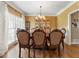 Elegant dining room featuring hardwood floors, a chandelier, and a classic china cabinet at 1605 Little Lisa Ln, Snellville, GA 30078