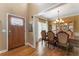 Formal dining room with chandelier, hardwood floors, and natural light through a large window at 1605 Little Lisa Ln, Snellville, GA 30078