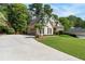Exterior elevation of the two-story home showing manicured lawn and three car garage at 1605 Little Lisa Ln, Snellville, GA 30078