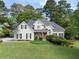 Charming two-story home boasts a lush green lawn and meticulously manicured landscaping at 1605 Little Lisa Ln, Snellville, GA 30078