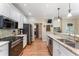 Spacious kitchen with stainless steel appliances, granite countertops, and hardwood floors at 1605 Little Lisa Ln, Snellville, GA 30078