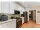 Bright kitchen features granite countertops, stainless steel appliances, and ample cabinet space at 1605 Little Lisa Ln, Snellville, GA 30078