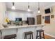 Bright kitchen features a breakfast bar with granite counters, white cabinets, stainless appliances, and pendant lighting at 1605 Little Lisa Ln, Snellville, GA 30078