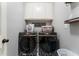 Laundry room featuring modern washer and dryer units, storage cabinets, and stylish design elements at 1605 Little Lisa Ln, Snellville, GA 30078